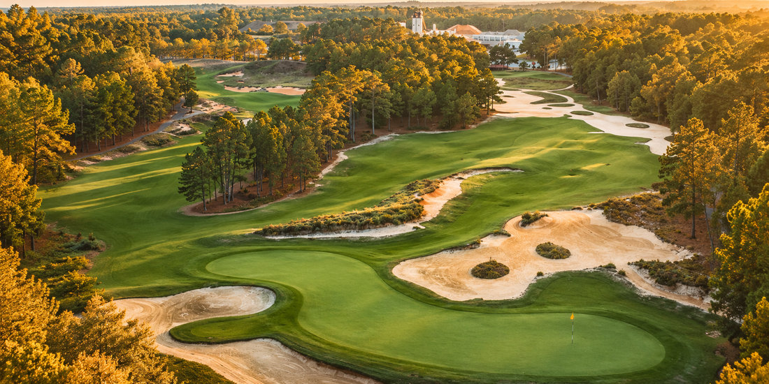 Aerial view of Tobacco Road Golf Club at golden hour, with waste areas, sculpted bunkers and winding fairways carved through the North Carolina pine forest